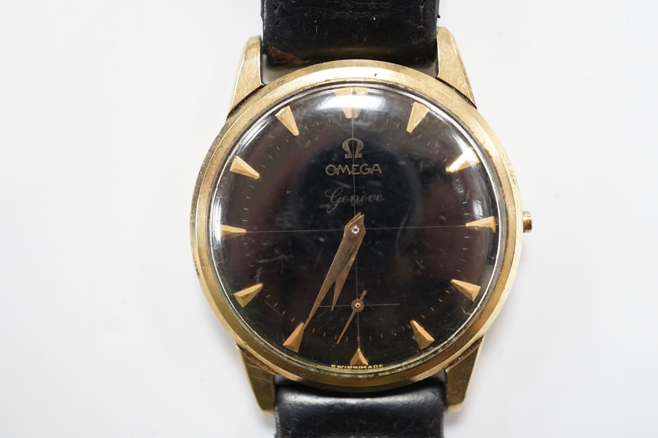 A gentleman's 9ct gold Omega manual wind black dial wrist watch (lacking winding crown), on associated leather strap, case diameter 35mm.